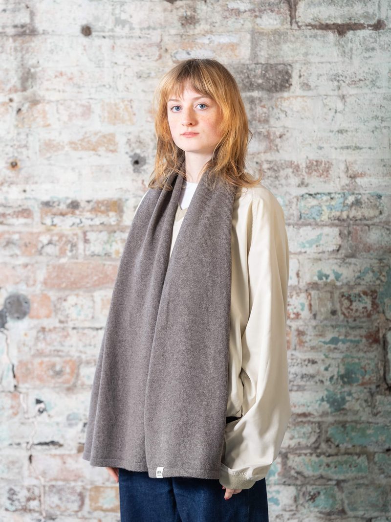 Woman Wearing Dark Brown Knitted Wide Merino Wool Scarf Woolkind by Woolkind